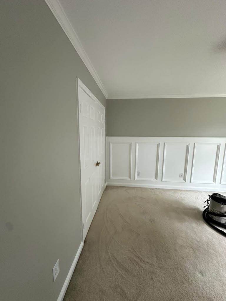 Bedroom with new white wainscoting panels, fresh paint and a ceiling fan